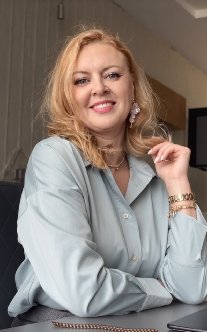 Andrea Florescu, operations consultant and fractional leader, smiling in a light blue shirt